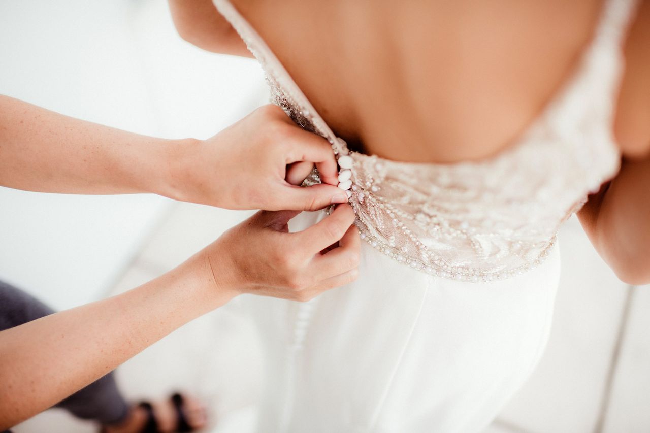 Woman trying on wedding dress (stock image)Credit: Getty