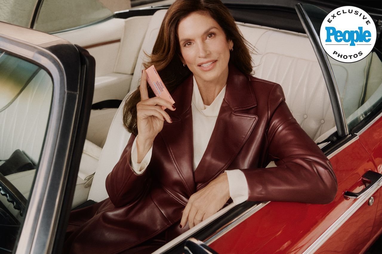 Cindy Crawford holding a product while seated in a car Cindy Crawford for UpneeqCredit: Upneeq