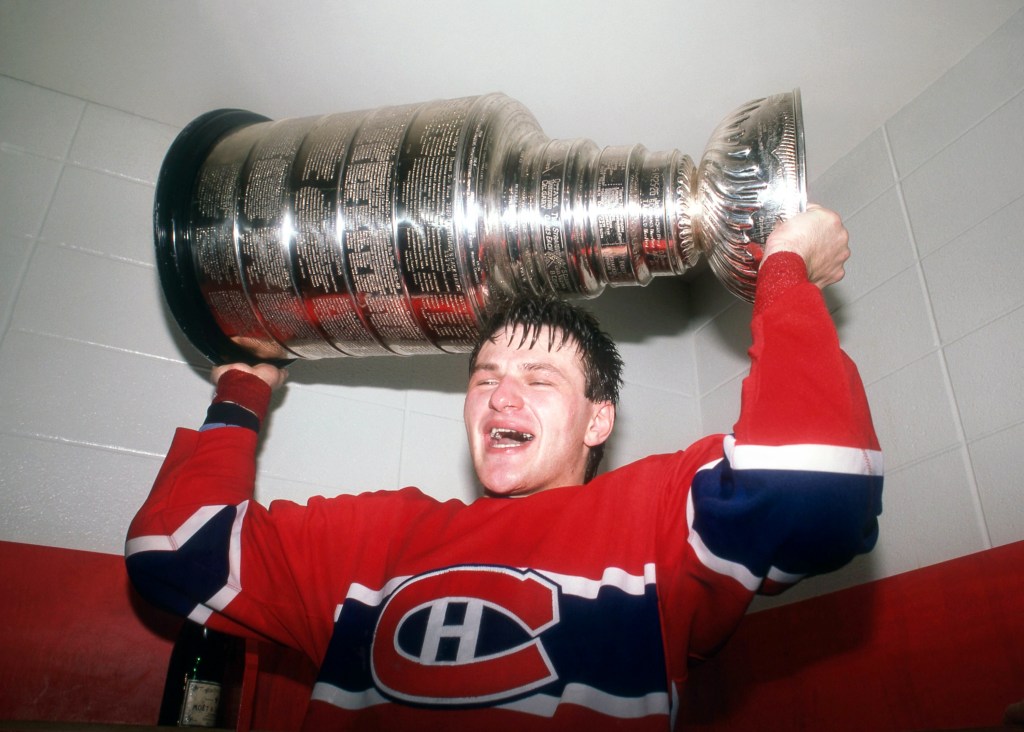 CALGARY, AB - MAY 24: Claude Lemieux #32 of the Montreal Candiens celebrates with the Stanley Cup Trophy in the locker room after defeating the Calgary Flames in Game 5 of the 1986 Stanley Cup Finals on May 24, 1986 at the Olympic Saddledome in Calgary, Alberta, Canada. (Photo by Bruce Bennett Studios via Getty Images Studios/Getty Images)