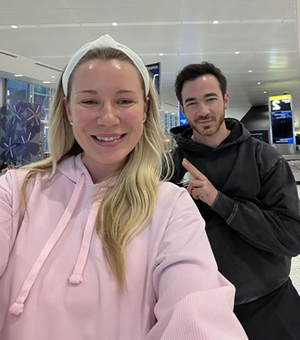 Emily Cline and Kevin Jonas at baggage claimCredit: Emily Cline, Founder of Wedding Day Content Creator