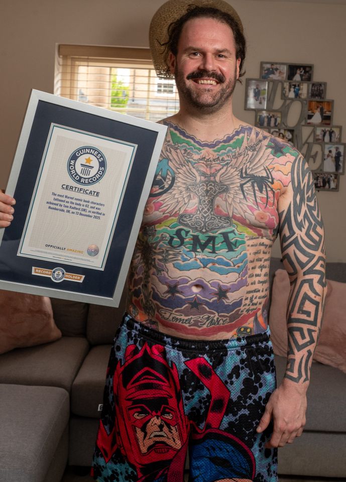 Tom Radford showing off his Guinness World Record plaque and tattoos.Credit: Charley Atkins/SWNS