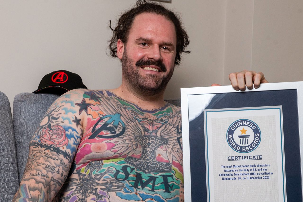 Tom Radford showing off his Guinness World Record plaque and tattoos.Credit: Charley Atkins/SWNS
