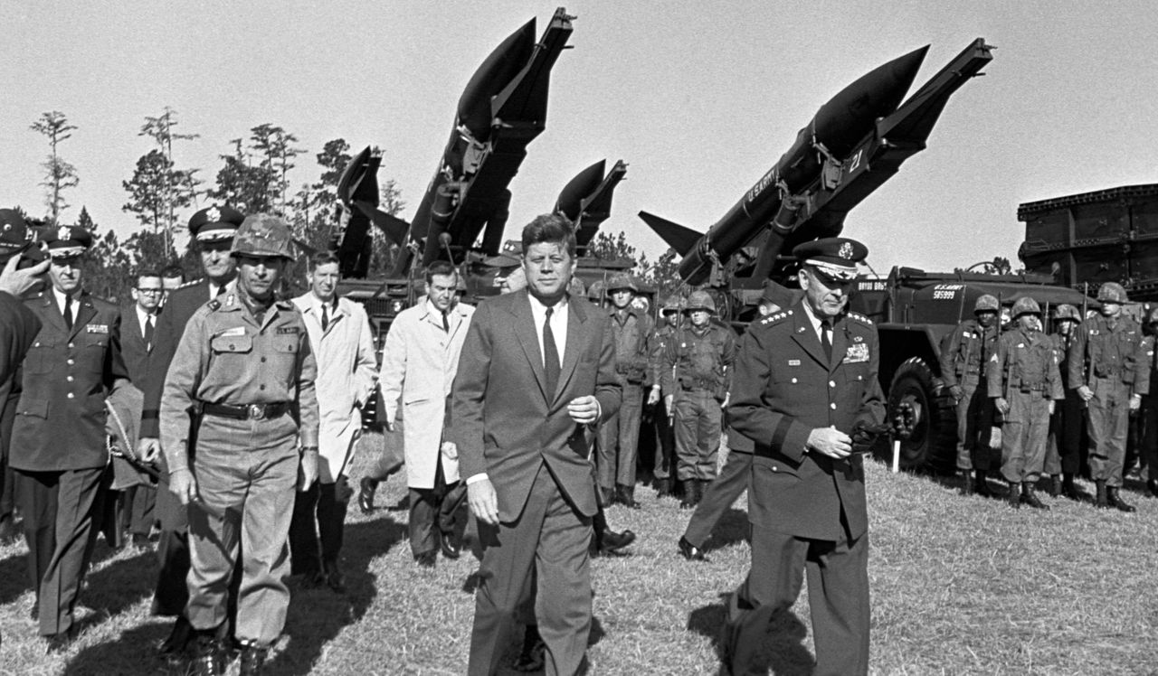 US President John F Kennedy (1917 - 1963, centre) during an inspection tour of units staged at Fort Stewart, Georgia, 26th November 1962. President John F Kennedy during an inspection tour of units staged at Fort Stewart, Georgia, on Nov. 26, 1962.Credit: Corbis via Getty