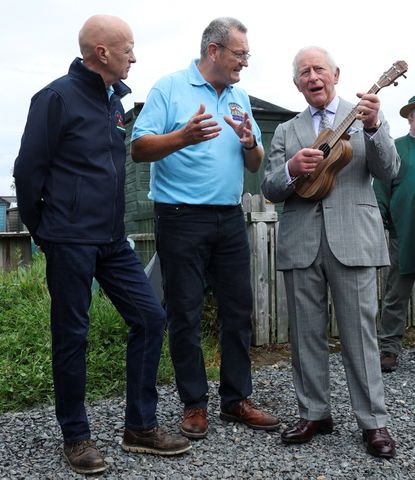 King Charles plays a ukulele during a visit to Ards Allotments in Newtownards, Northern Ireland, on May 21, 2026Credit: Toby Melville / POOL / AFP via Getty