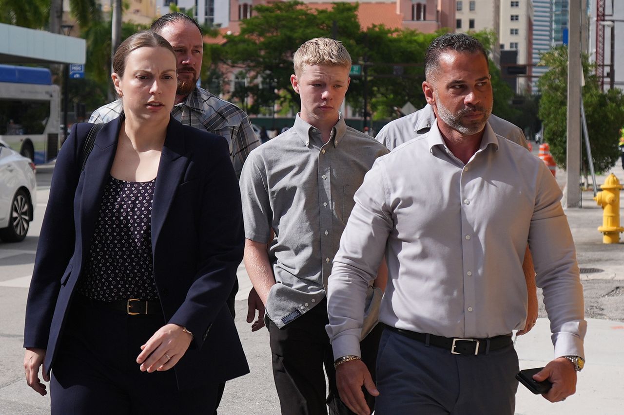 T.H. with his public defender (left) and father Thomas Hudson (back left)Credit: AP Photo/Rebecca Blackwell