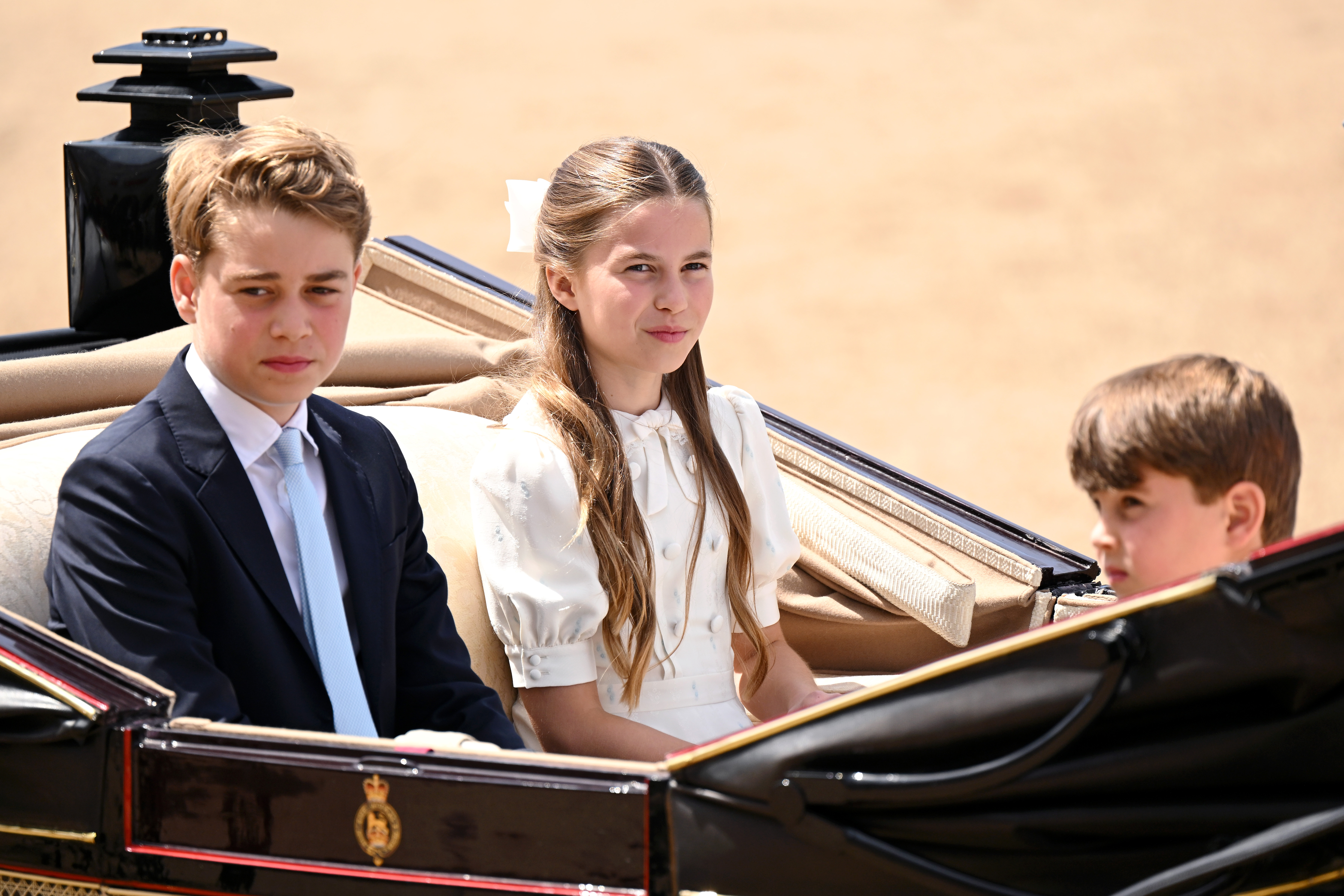Prince George of Wales, Princess Charlotte of Wales and Prince Louis of Wales  pass through the Trooping The Colour parade.