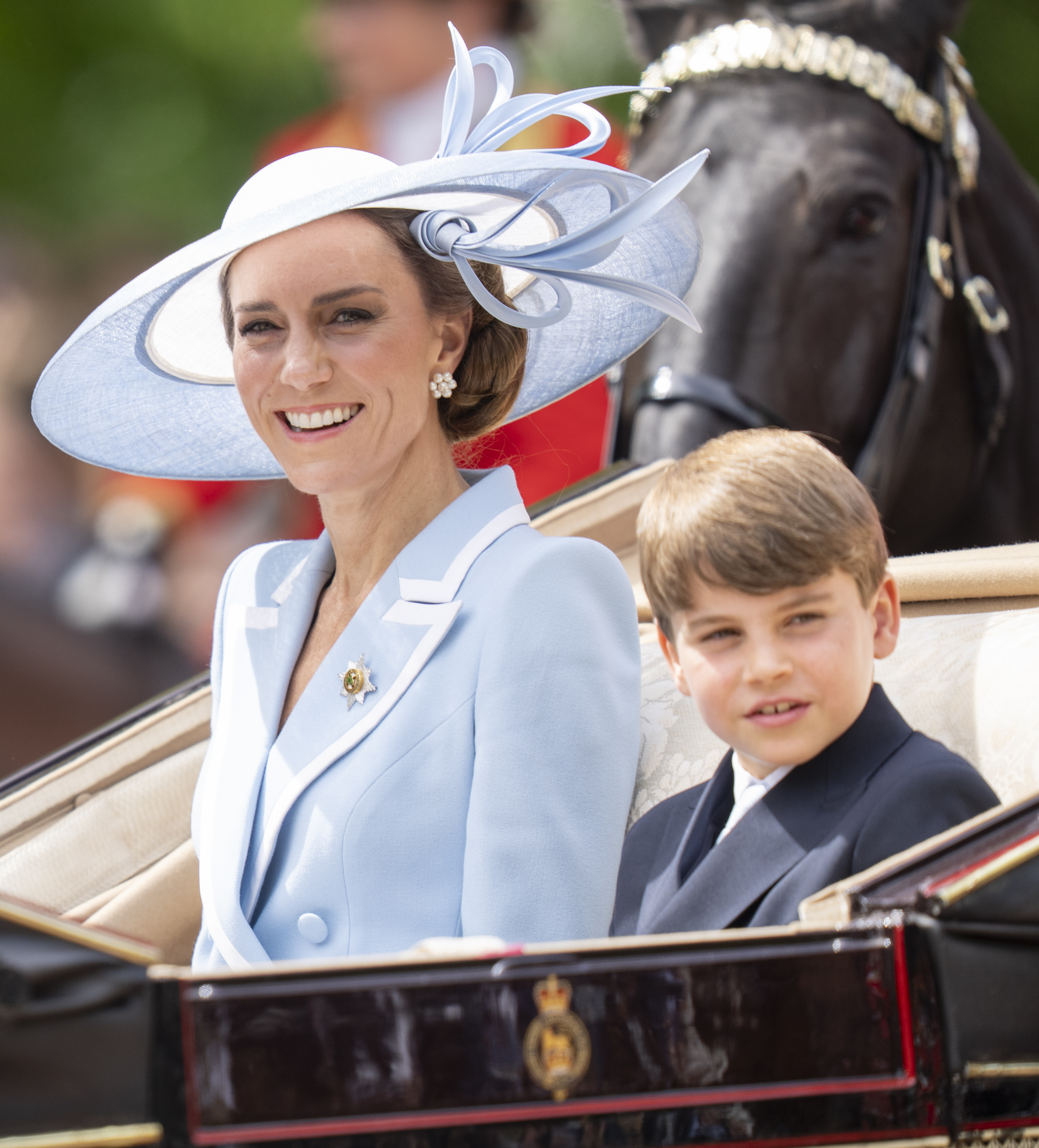 Catherine, Princess of Wales and Prince Louis of Wales pass through the Trooping The Colour parade.