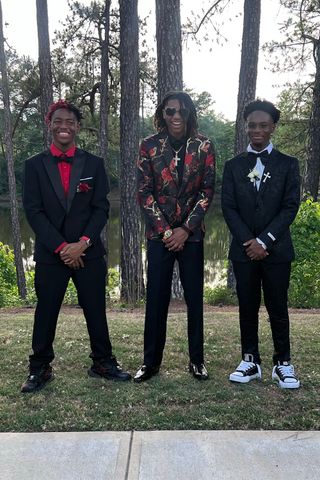 Collin Gates (far right) and best friends Necco Foster (left) and Ja’Qua Tucker attend prom in May 2026.Credit: Courtesy of Tamara Gates