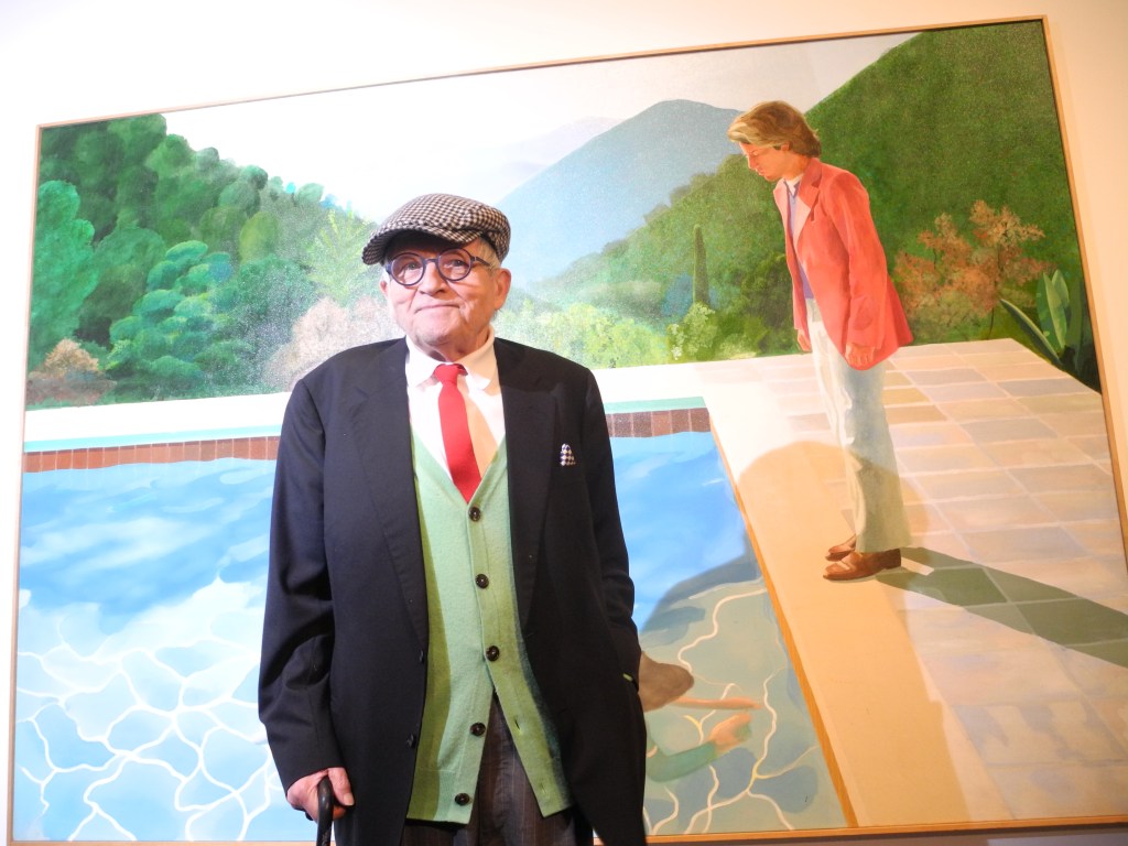 David Hockney standing in front of his "Portrait of an Artist (Pool with Two Figures)" painting at the Metropolitan Museum of Art in New York, USA, 20 November 2017. The Museum is dedicating a large retrospective to the work of Hockney, which spans almost 60 years. Photo: Johannes Schmitt-Tegge/dpa (Photo by Johannes Schmitt-Tegge/picture alliance via Getty Images)