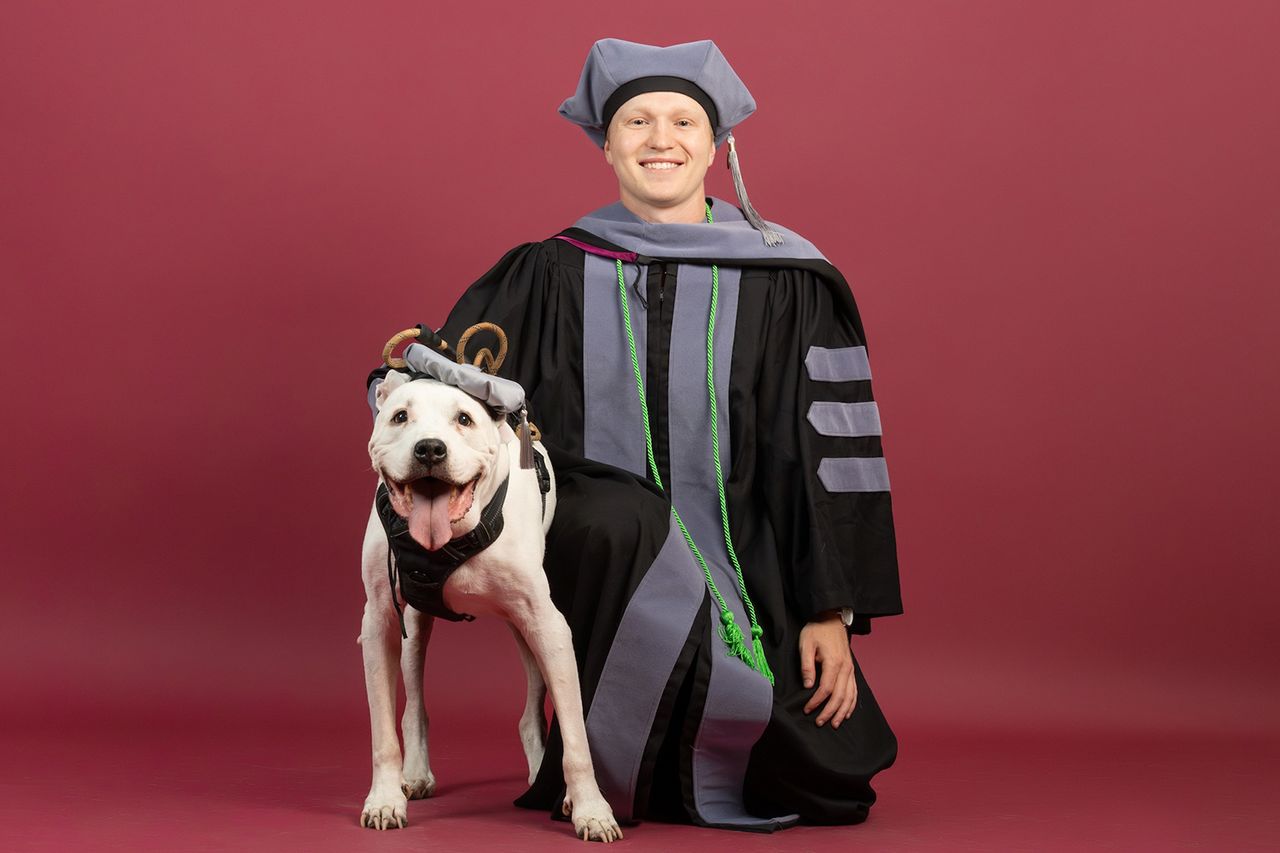 he Virginia-Maryland College of Veterinary Medicine Class of 2026 in their commencement regalia with their pets. Max Pasquinelli and his dog, HunterCredit: Madison Brown/Virginia Tech