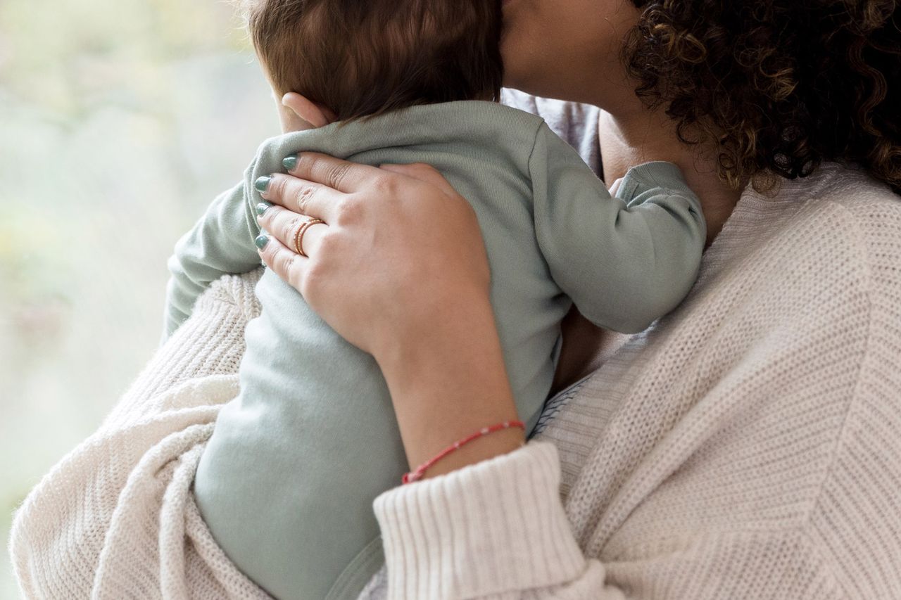 A woman holding a baby (stock image).Credit: Getty