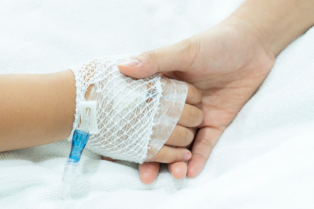Stock photo of hands holding at a hospital. A person holding a child’s hand in the hospital (stock image)Credit: Getty