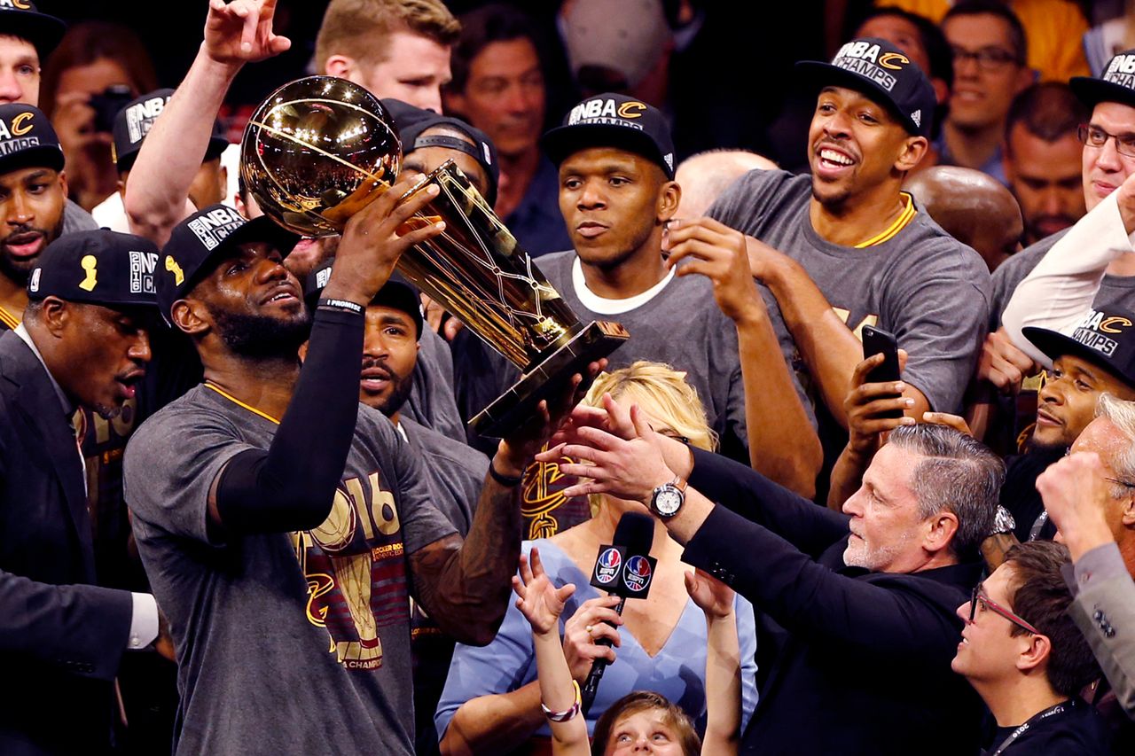 Cleveland Cavaliers' LeBron James hoists the Larry O'Brien trophy after winning the NBA Finals on June 19, 2016 in Oakland, California.Credit: Beck Diefenbach / AFP via Getty