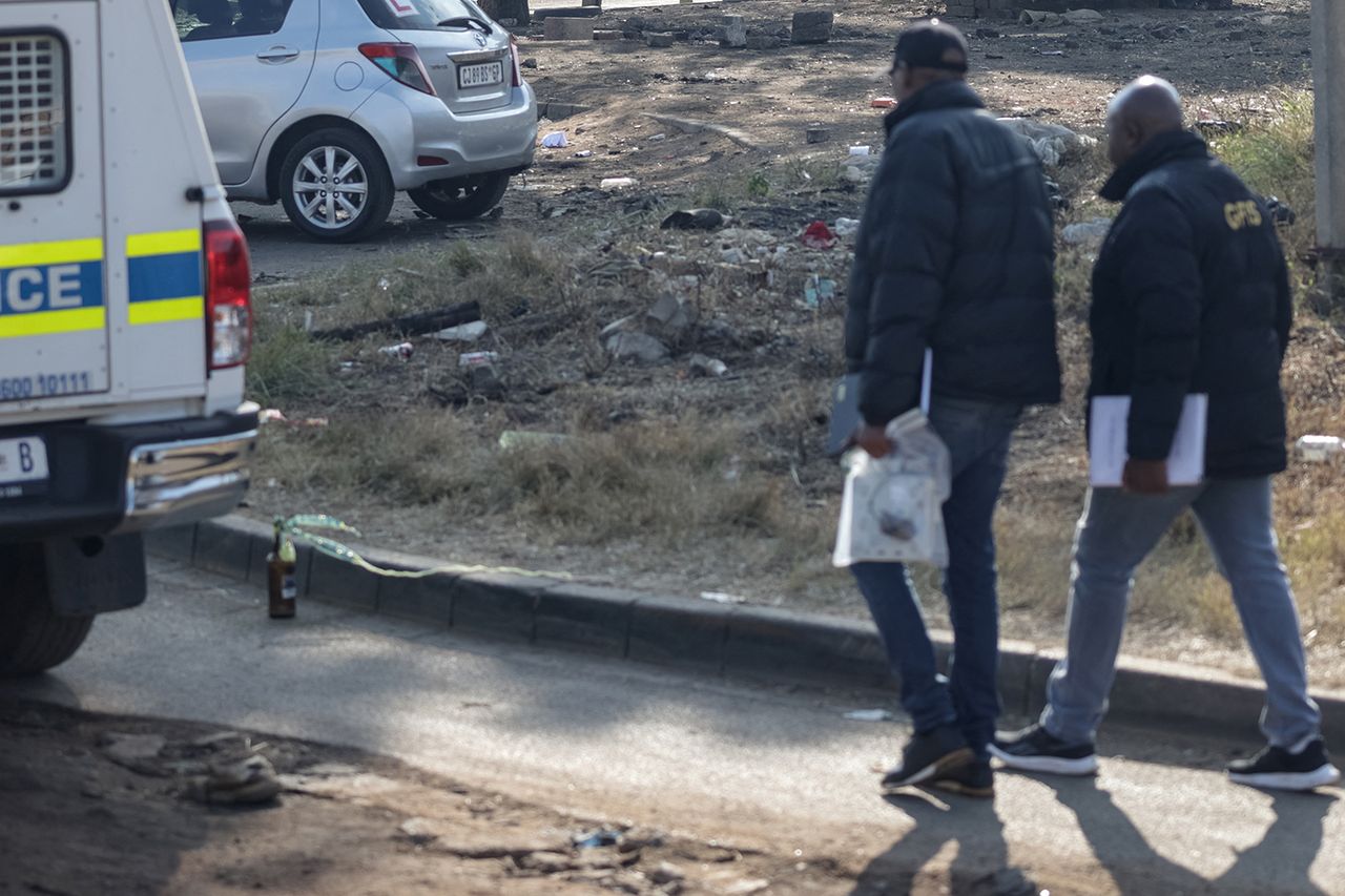 Crime scene investigators at Jumpers informal settlement in Cleveland, east of Johannesburg Police at the scene if the mass shooting in JohannesburgCredit: EMMANUEL CROSET / AFP via Getty