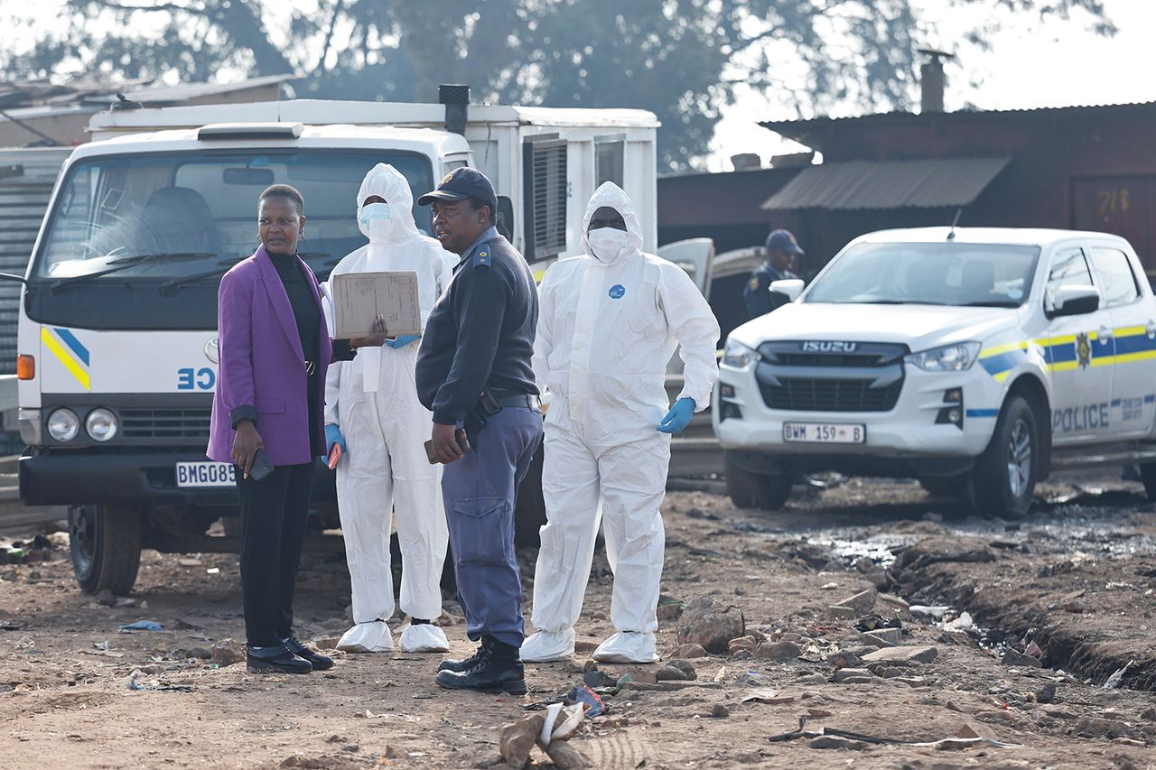 South African Police Services members prepare to work at the scene of a mass shooting in Cleveland Police at the scene if the mass shooting in JohannesburgCredit: Kim Ludbrook/EPA/Shutterstock