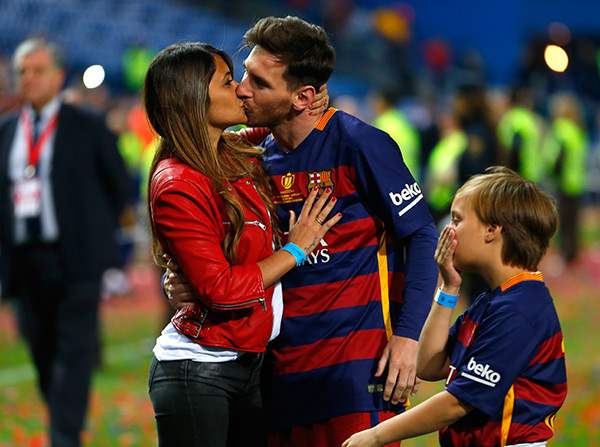 Lionel Messi kisses his wife