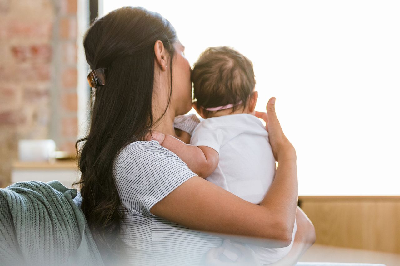 A woman holding a baby (stock image).Credit: Getty