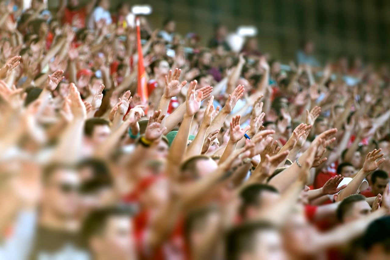 Stock image of large crowd cheering in stadium Stock image of sports fans packed into a crowdCredit: Getty