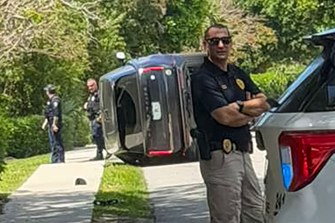 Tiger Wood's Car is seen turned on its side following crash in Florida The scene from Tiger Woods' crashCredit: Shabba / BACKGRID