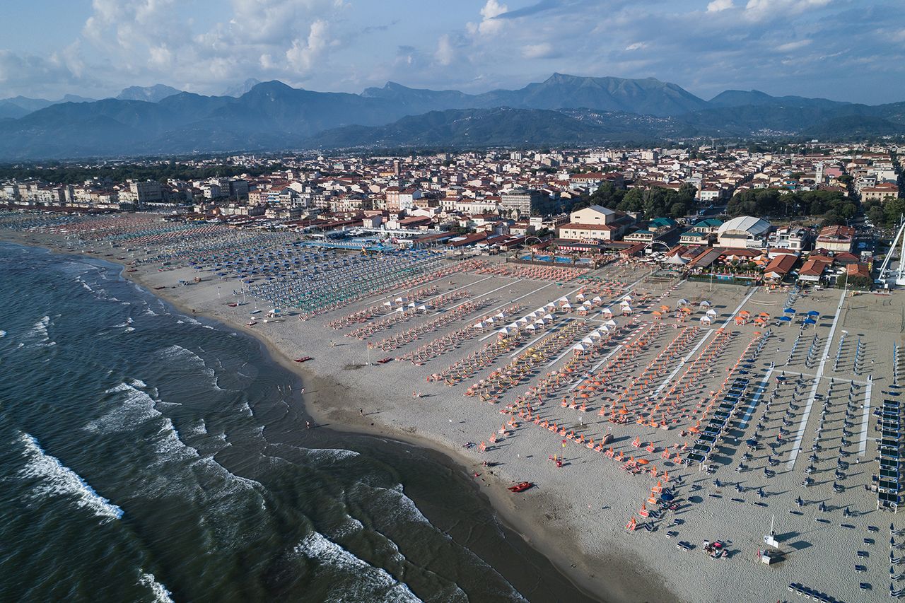 Aerial shot showing umbrellas lined up on beach, Viareggio, Italy - stock photo Viareggio, ItalyCredit: Getty