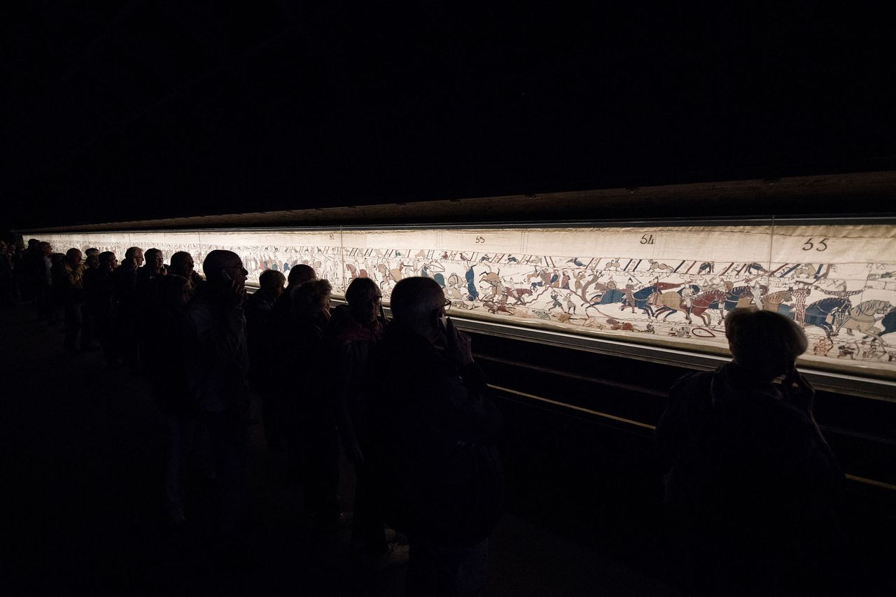 People look at the The Bayeux Tapestry on display.Credit: LOIC VENANCE/AFP via Getty