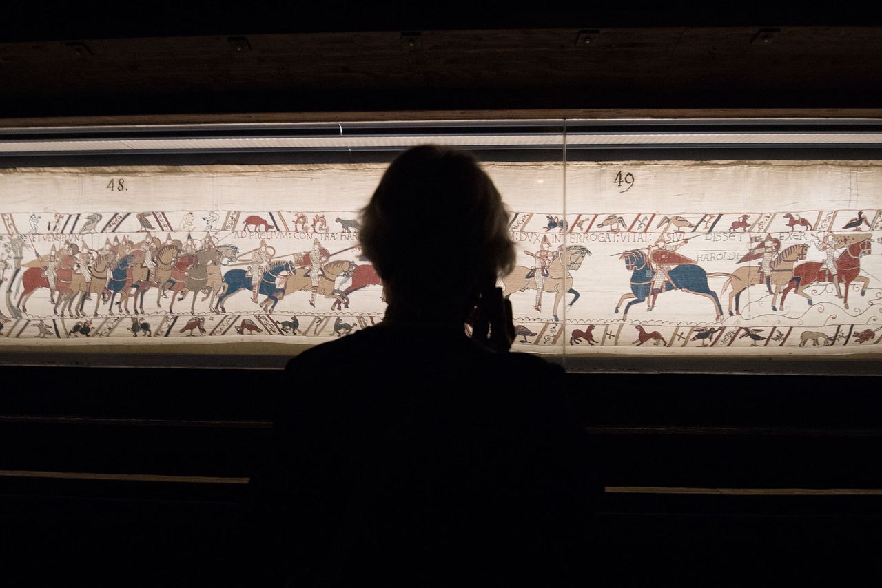 A visitor looks at the A portion of the Bayeux Tapestry on display.Credit: LOIC VENANCE/AFP via Getty