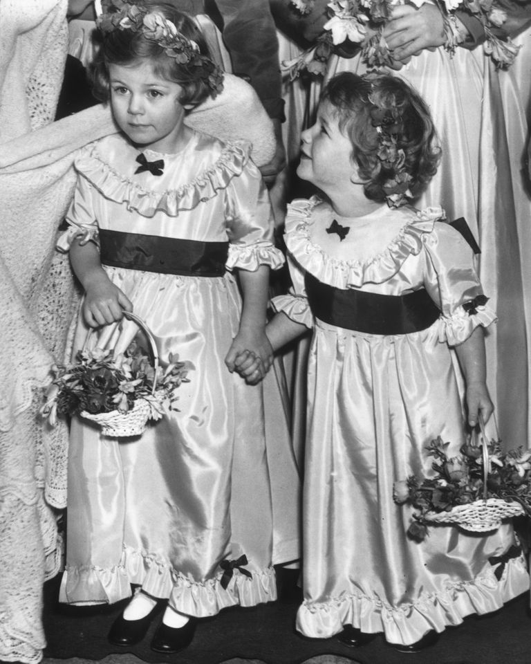 Bridesmaids and sisters 4-year-old Camilla and 3-year-old Annabelle Shand, at the wedding of Jeremy Cubitt and Diana du Cane Camilla and Annabelle Shand in 1952Credit: William Vanderson/Fox Photos/Getty