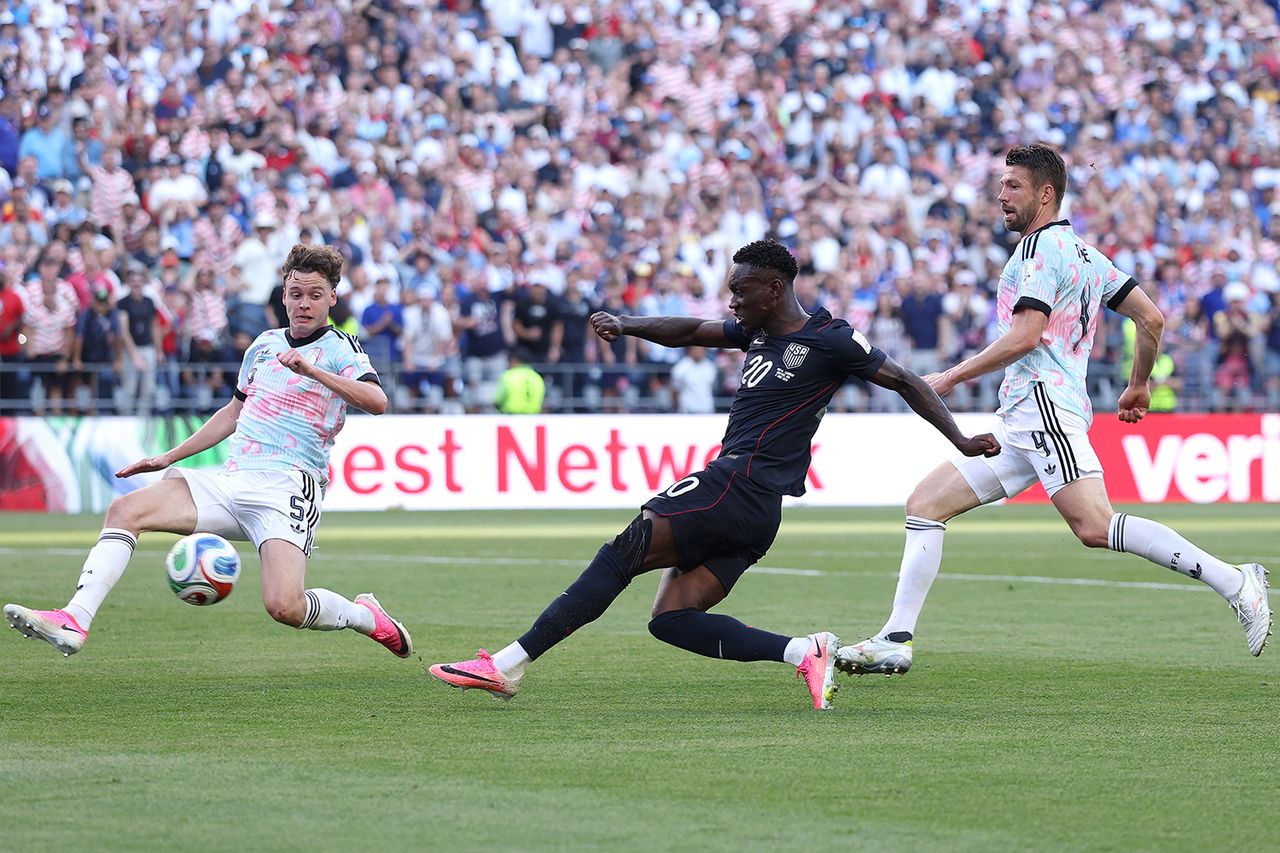 Folarin Balogun #20 of the United States shoots and misses a chance against Maxim De Cuyper #5 and Brandon Mechele #4 of Belgium during the FIFA World Cup 2026 Round of 16 match between USA and Belgium at Seattle Stadium on July 06, 2026 in Seattle, Washington. Maxim De Cuyper (left), Folarin Balogun (center) and Brandon Mechele (right)Credit: Carl Recine/Getty