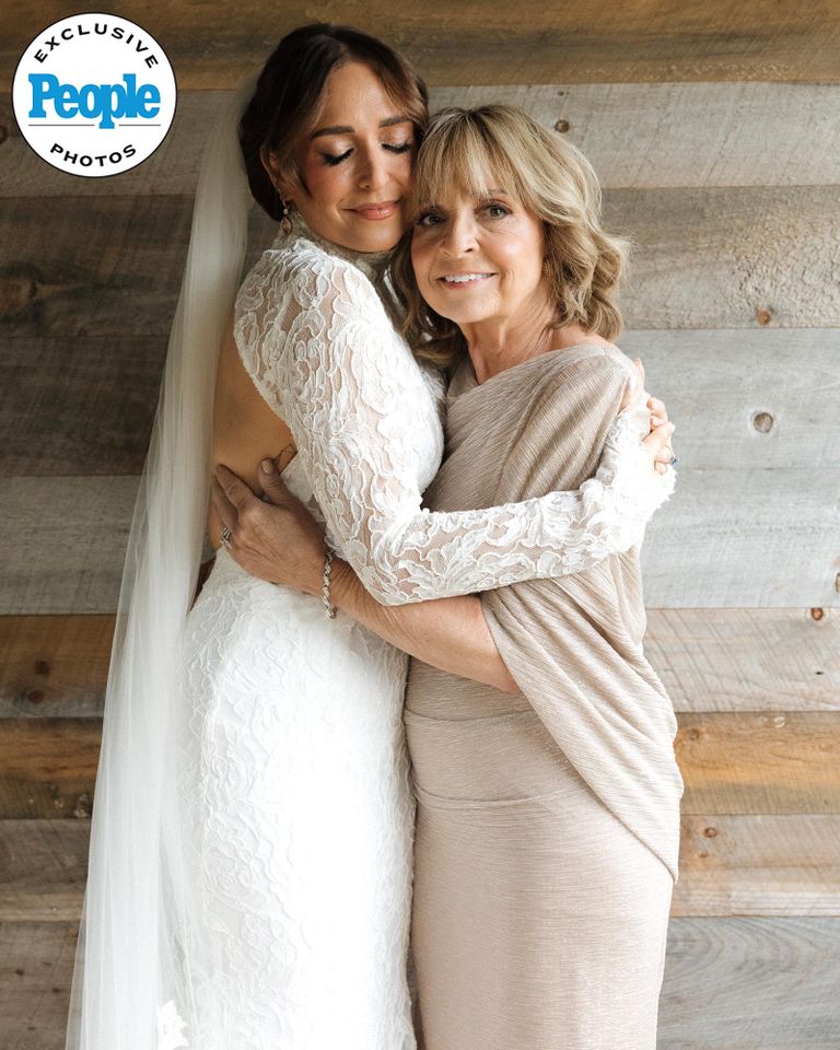 Jessica Vosk, while wearing her Neta Dover wedding dress, hugs her motherCredit: Laurel Hinton