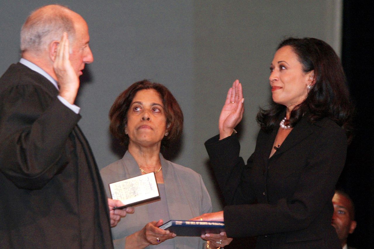 Kamala Harris is sworn in as the San Francisco district attorney on Jan. 8, 2004, alongside her mother, Dr. Shyamala GopalanCredit: AP Photo/George Nikitin