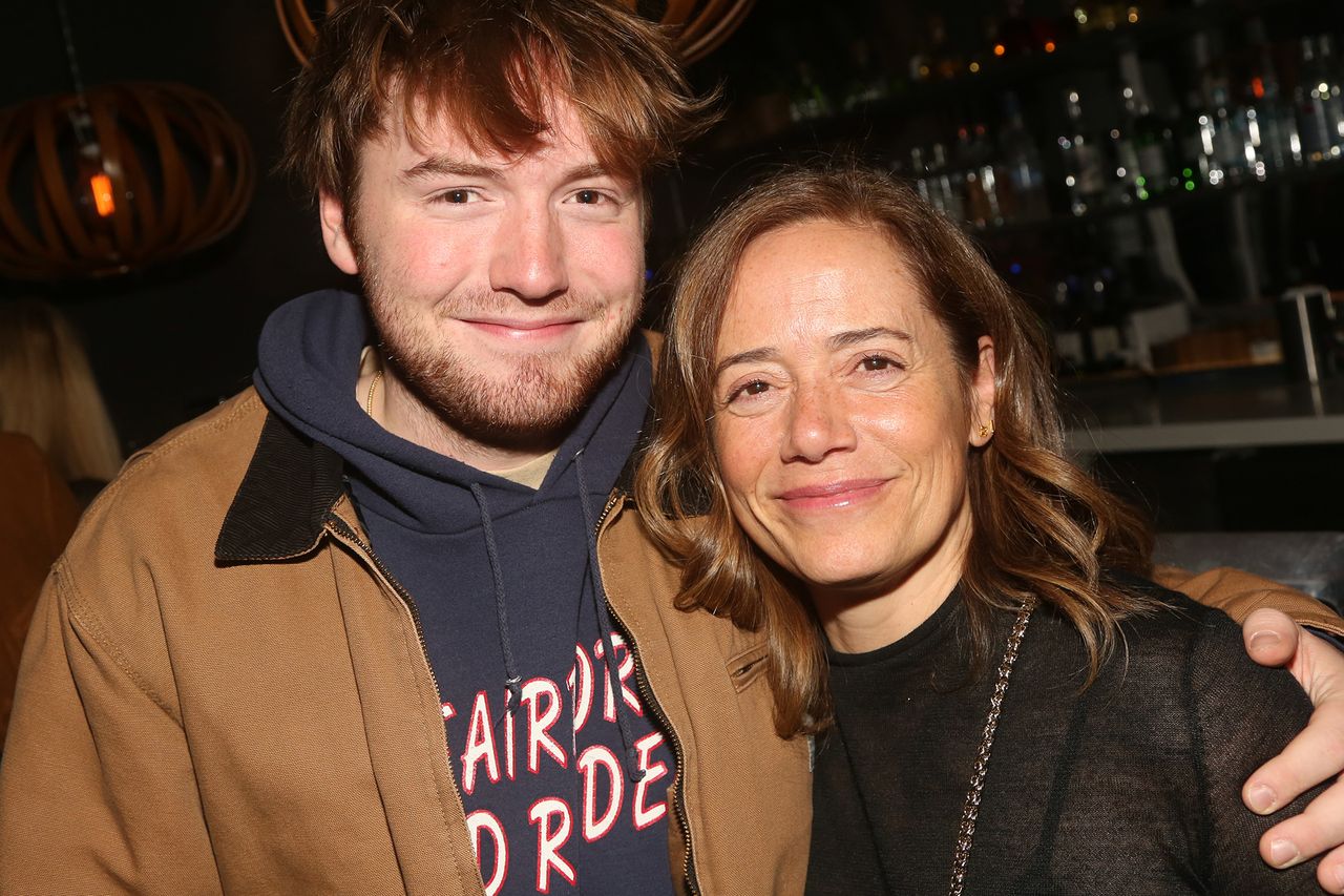 Two people smiling one places hand on the others shoulder indoor setting with a bar in background Cooper Hoffman and mother Mimi O’Donnell pose at the opening night party for The New Group Theater’s new play “Sabbath’s Theater” at Green Fig Urban Eatery on November 1, 2023, in New York CityCredit: Bruce Glikas/Getty