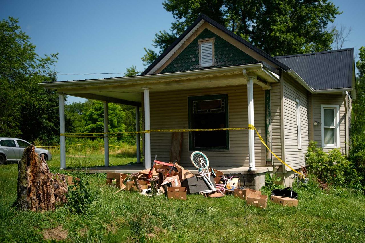 Police tape surrounds a home where authorities say they removed 16 children and arrested four adults in Hamden, Ohio, Wednesday, July 1, 2026. The home where four adults were found living with 16 children in Ohio.Credit: Carolyn Kaster/AP