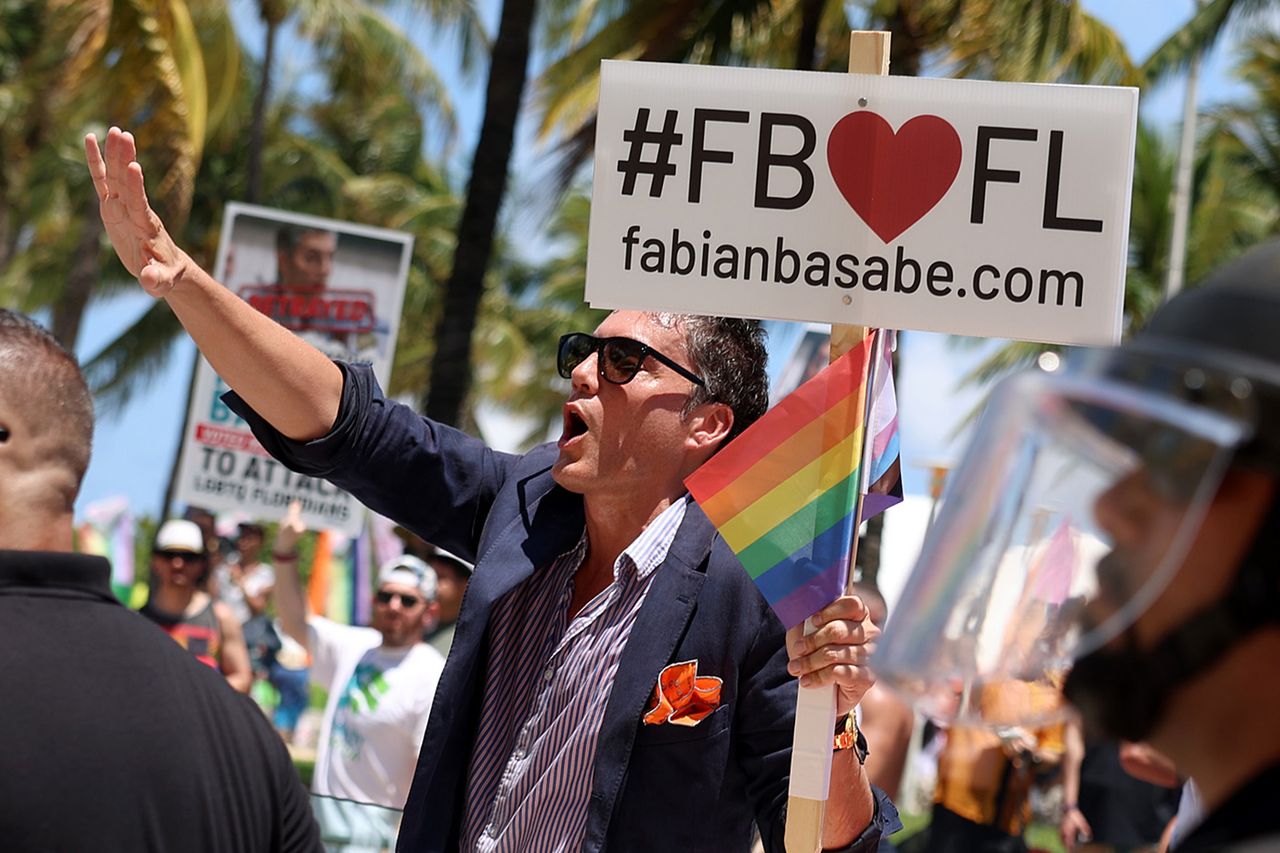 Florida State House Rep. Fabián Basabe (R) is flanked by security as he rides in the 15th annual Miami Beach Pride Celebration parade on April 16, 2023 in Miami Beach, Florida. Basabe was met with angry parade goers after they say he voted recently to advance legislation in the Florida House that advocates say will stigmatize and dehumanize the LGBTQ community. The parade featured a celebration of the LGBTQ+ community with floats, drag performers, and other parade participants. Florida state Rep. Fabián Basabe is flanked by security as he rides in the 15th annual Miami Beach Pride Celebration parade on April 16, 2023.Credit: Joe Raedle/Getty