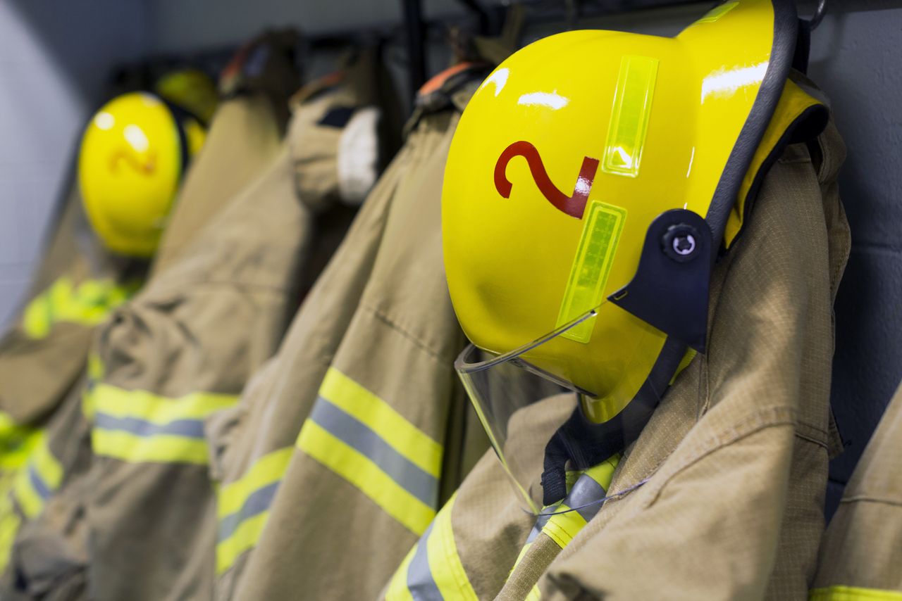 Coats and helmets of fire fighters hanging on hooks Firefighter gear (stock image)Credit: Tetra Images RF/Getty