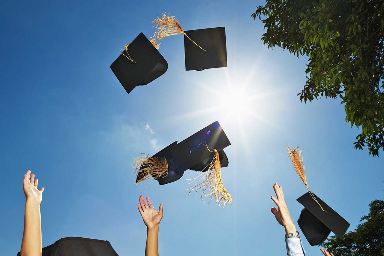 graduation cap toss Graduates tossing their caps (stock image)Credit: Getty