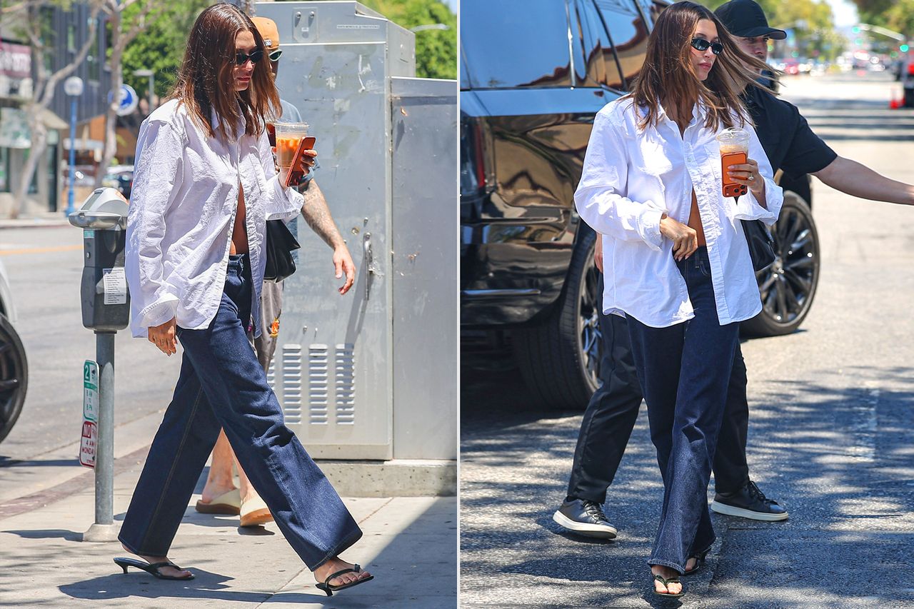 Justin Bieber and Hailey Bieber were spotted arriving at a spa on Saturday evening in Los Angeles, California, in their brand-new Bentley SUV. Hailey kept it chic in an oversized white button-down shirt, dark blue jeans, sunglasses, and loafers, while Justin opted for a cropped navy T-shirt, athletic shorts worn low enough to reveal his underwear waistband, slip-on shoes, and a baseball cap Credit: BACKGRID