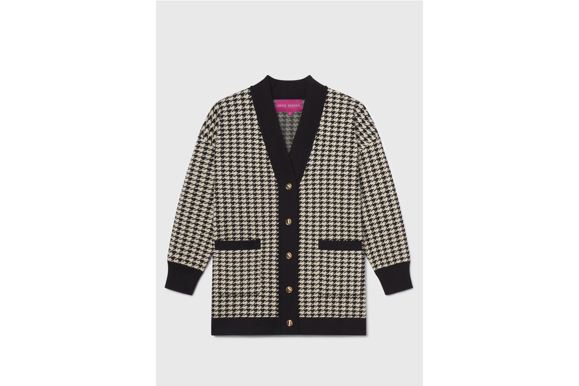 Black and white houndstooth cardigan with gold buttons.