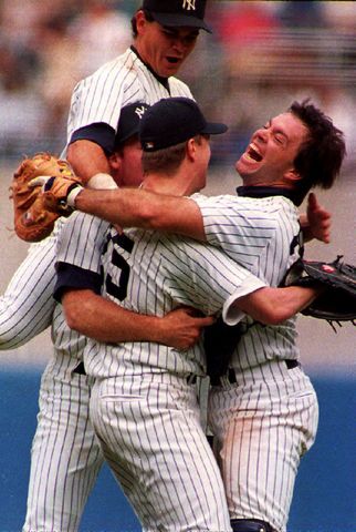 New York Yankees pitcher Jim Abbott (C) is grabbed by catcher Matt Nokes (R) after he completed New York's first no-hitter in 10 years 04 September 1993, in new York, New York. Abbott, who was born without a right hand, walked five and struck out three as the Yankees defeated the Cleveland Indians 4-0. Jim Abbott celebrating with his teammates after pitching a no-hitter in 1993Credit: MARK D. PHILLIPS/AFP via Getty