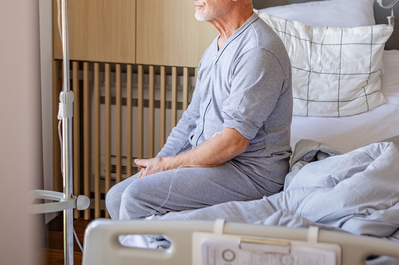 A senior man sits on the edge of a hospital bed Man in hospital room (stock image)Credit: Getty