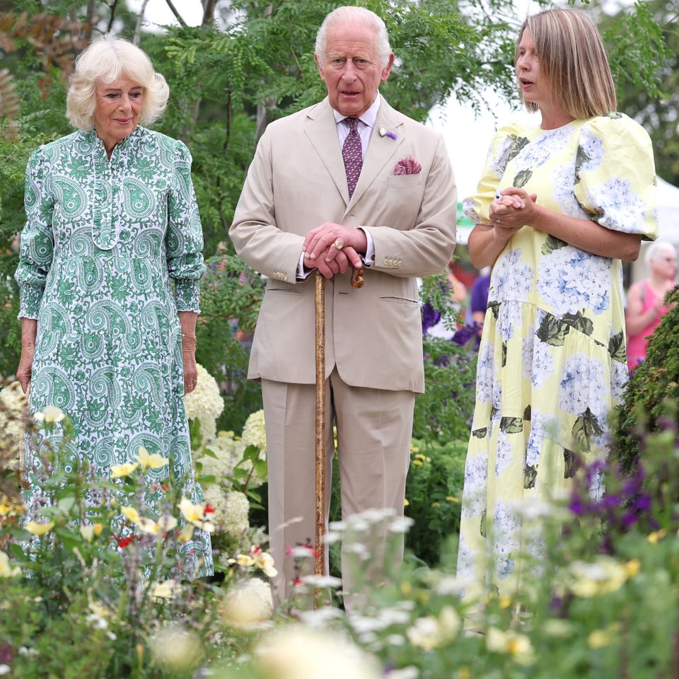 Queen Camilla and King Charles III speak with garden designer Catherine MacDonald as they visit the Royal Legacy Garden at the RHS Sandringham Flower Show on July 22, 2026Credit: Chris Jackson/Getty