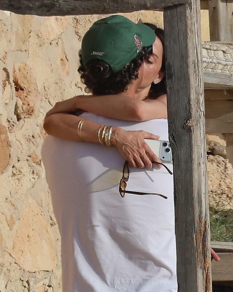 A man and a woman embracing outdoors near a wall the woman holds a phone Ana de Armas and Beto Montenegro in Formentera on Aug. 2Credit: COBRA TEAM / BACKGRID