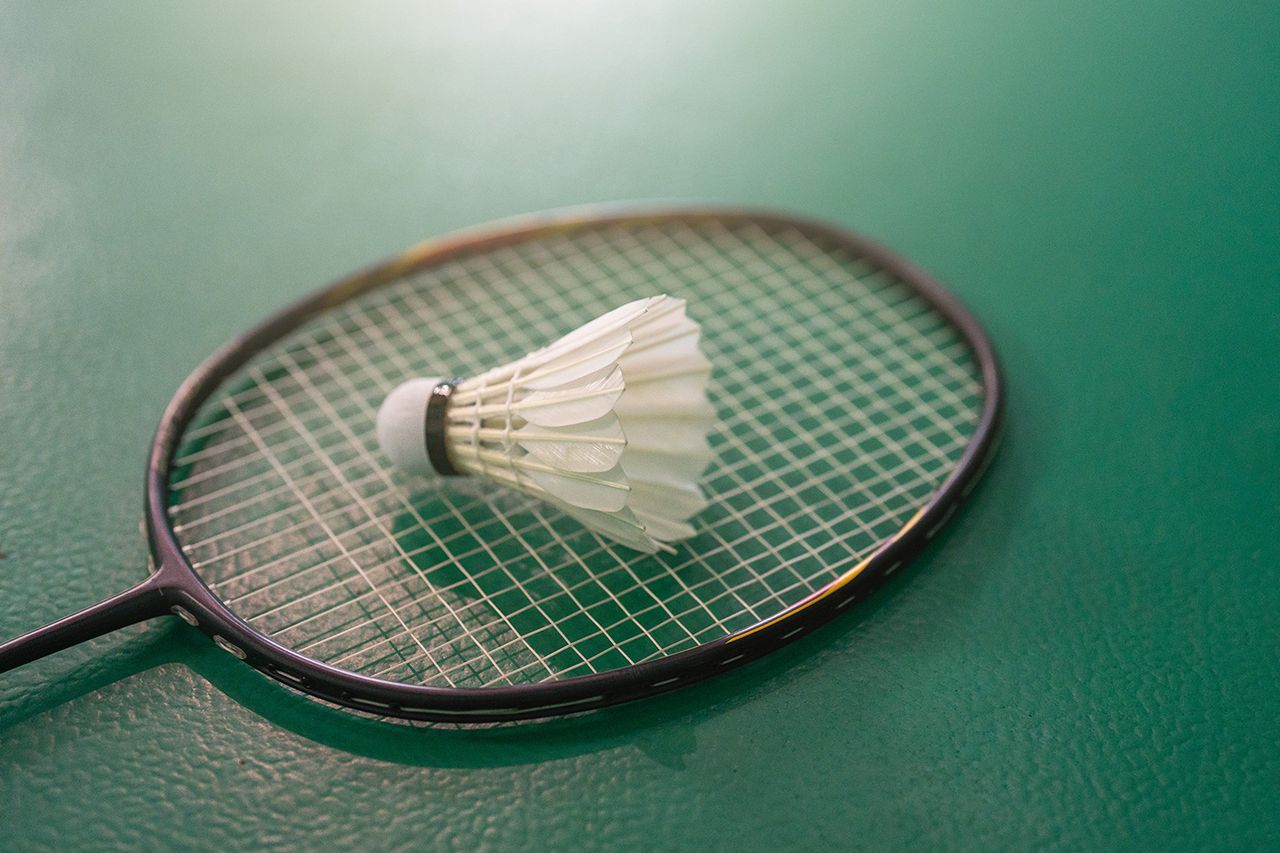 Close up shuttlecocks on racket bad mintons at badminton courts with players competing Badminton racket (stock image)Credit: Getty