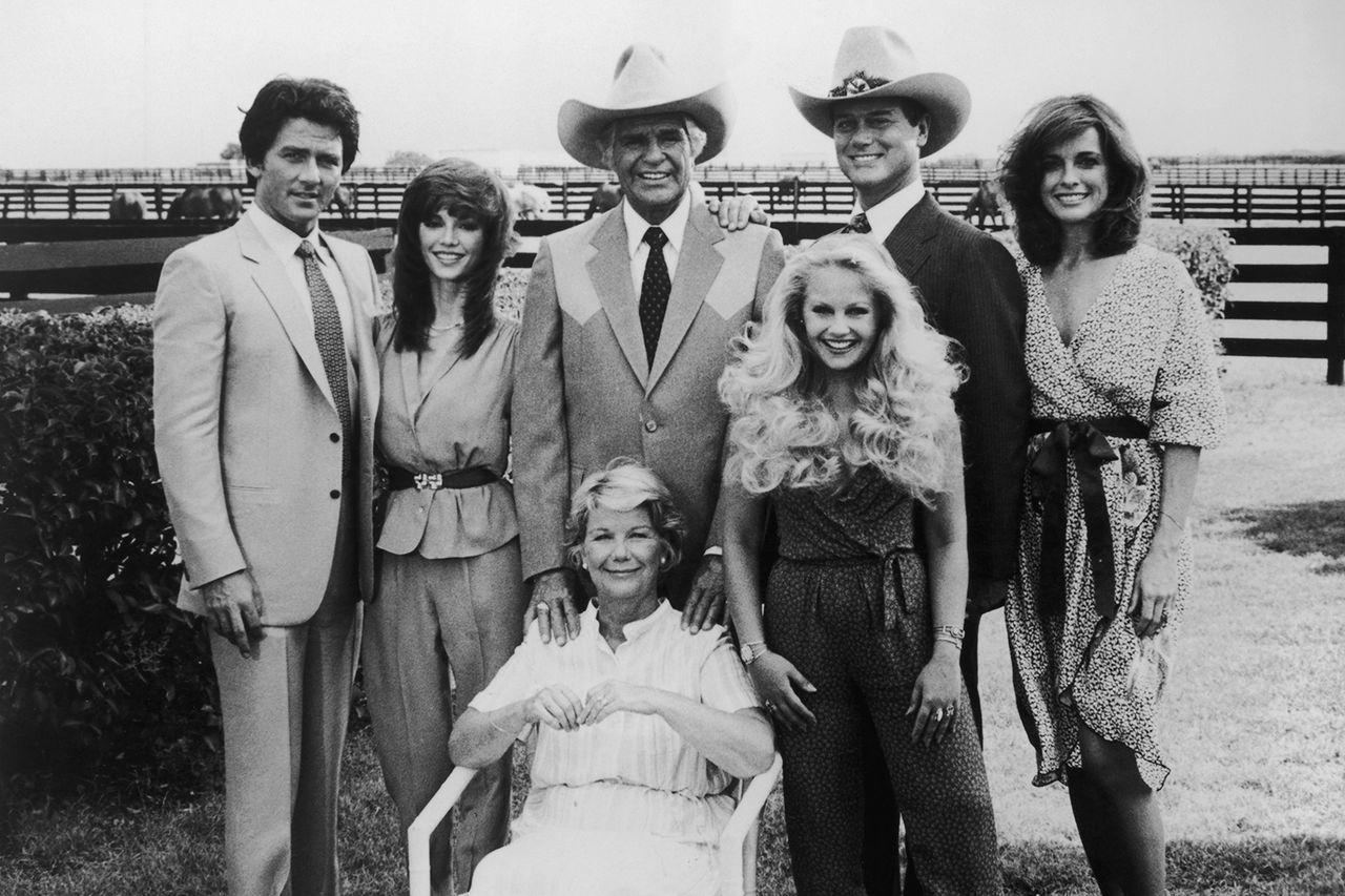 A group portrait of the Ewing family from the U.S. television soap opera 'Dallas', circa 1980. Standing, left to right: Bobby (Patrick Duffy), Pam (Victoria Principal), Jock (Jim Davis, 1909 - 1981), Lucy (Charlene Tilton), J.R. (Larry Hagman) and Sue Ellen (Linda Gray). Seated: Miss Ellie (Barbara Bel Geddes, 1922 - 2005) Bobby (Patrick Duffy), Pam (Victoria Principal), Jock (Jim Davis), Lucy (Charlene Tilton), J.R. (Larry Hagman) and Sue Ellen (Linda Gray). Seated: Miss Ellie (Barbara Bel Geddes)Credit: Hulton Archive/Getty