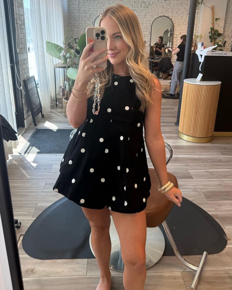 A person taking a mirror selfie in a salon setting wearing a polka dot dress and holding a phone Chelsea Hunter snaps a mirror selfie.Credit: Chelsea Hunter