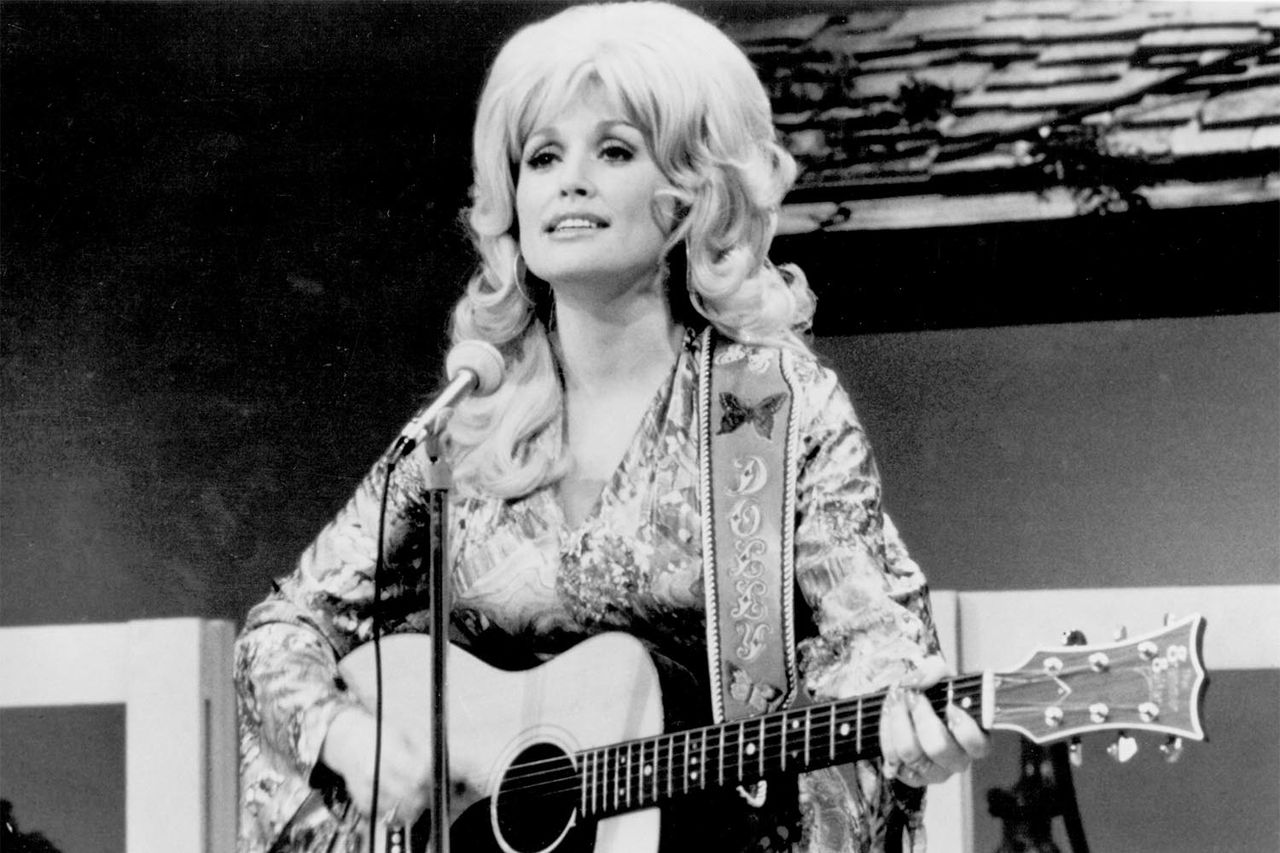 Country singer Dolly Parton performs onstage with an acoustic guitar in circa 1974.Credit: Michael Ochs Archives/Getty