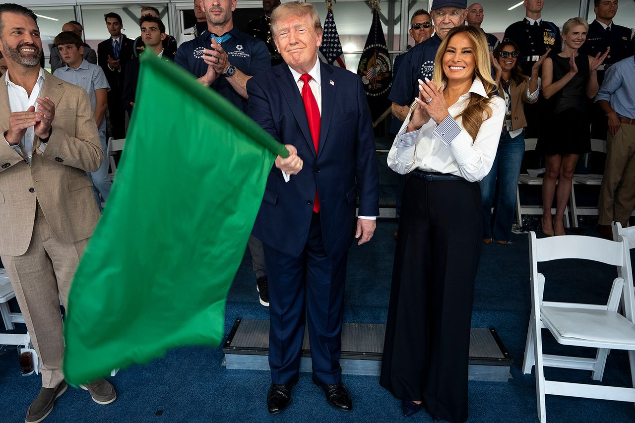 President Donald Trump waves the green flag to start the race with first lady Melania Trump and Donald Trump Jr. at the NTT INDYCAR Series on August 23, 2026 in Washington, DC. U.S. President Donald Trump waves the green flag to start the race with first lady Melania Trump. Natalie Harp is clapping in the back right of the frameCredit: Doug Mills - Pool/Getty