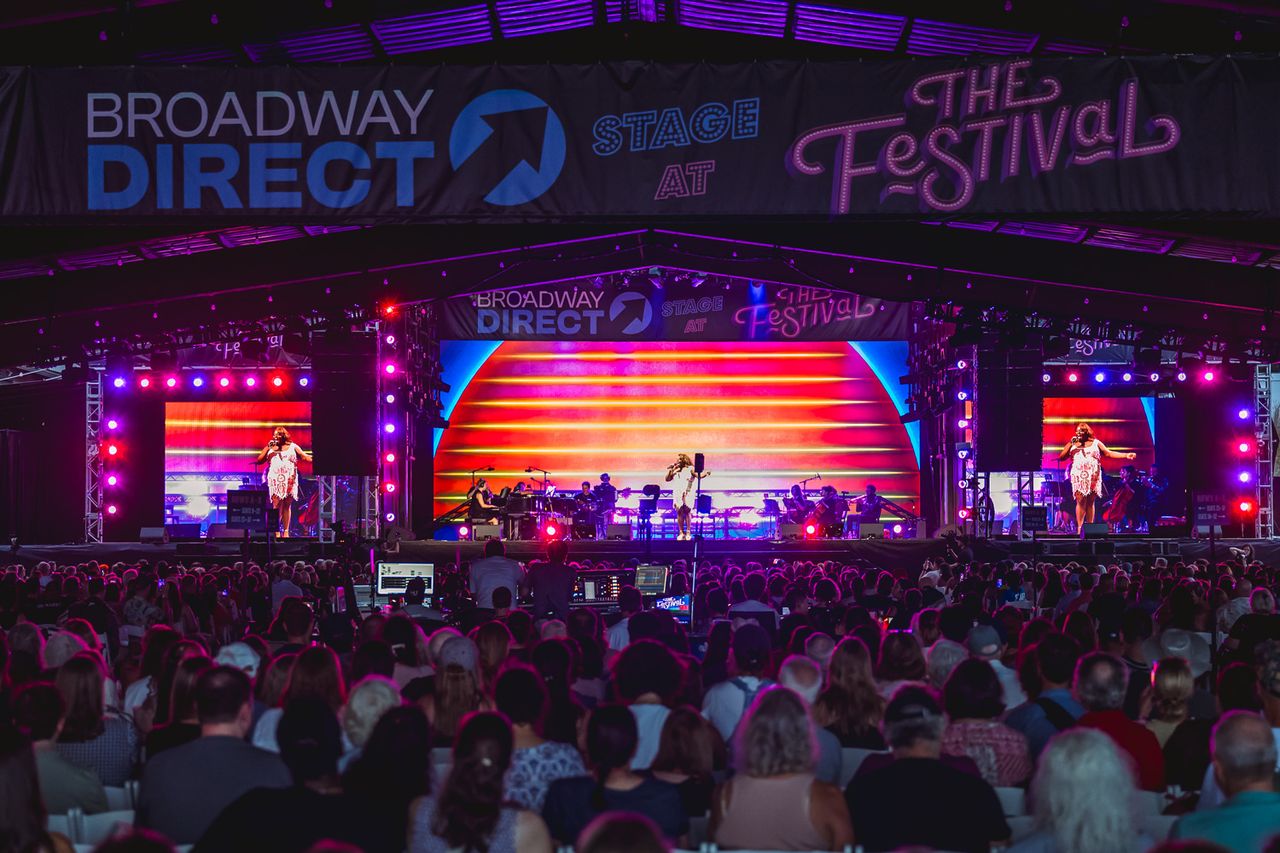 A live performance on a stage with a large crowd featuring musical artists and vibrant background visuals Alex Newell performs at the Broadway Direct Stage at The Festival on Friday, Aug. 14 at Hutton Brickyards Riverfront Hotel + Venue in Kingston, N.Y.Credit: Austin Ruffer