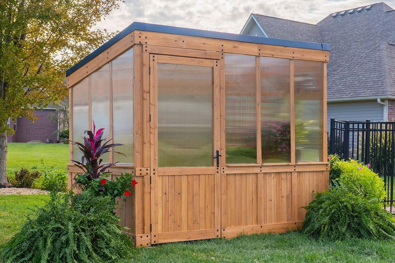 Backyard Discovery Willow 9' x 6' Cedar Wood and Polycarbonate Walk-in Greenhouse Kit Credit: Amazon