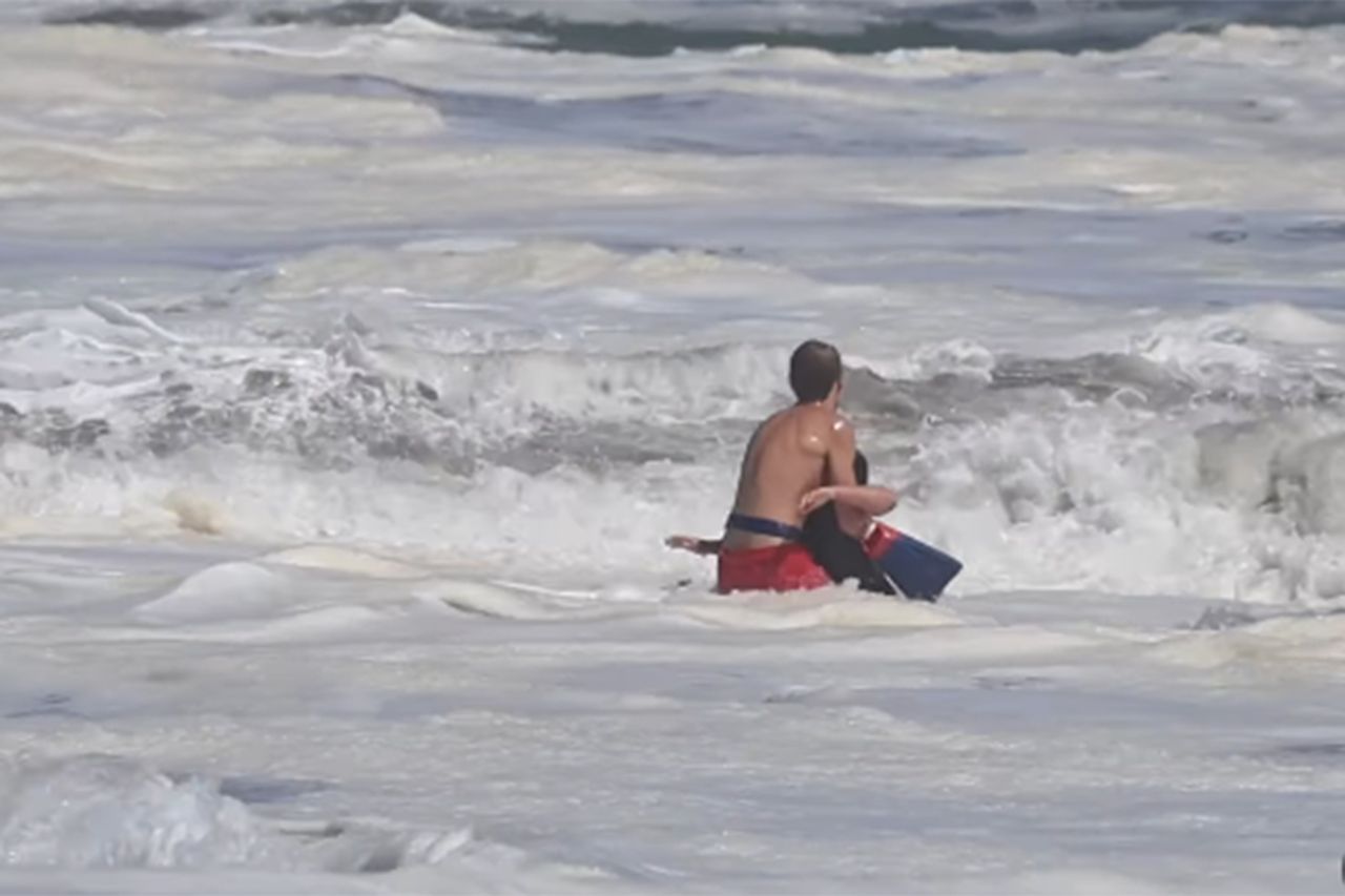 A lifeguard rescuing a swimmer in rough ocean waters Ryder Williams rescuing 10-year-old NathanielCredit: santacruznow/instagram