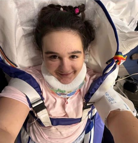 A young woman smiling while wearing medical support gear taken from an overhead perspective Abby BuellCredit: gofundme